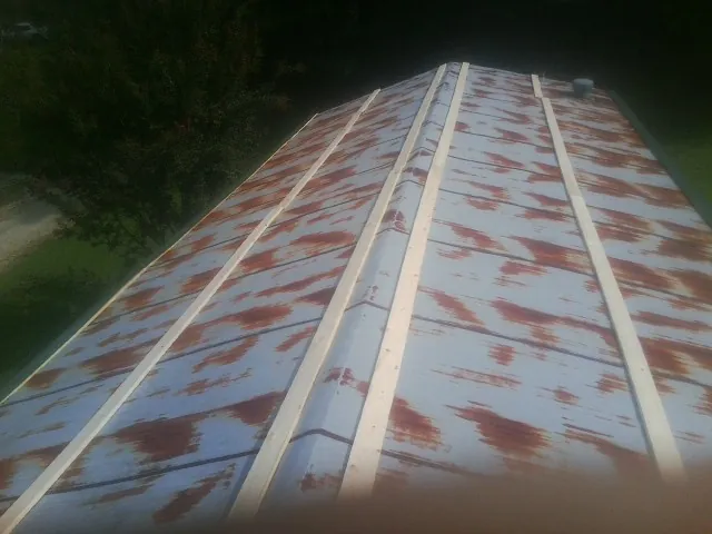 Rusted metal roof panels with new wood purlins before replacement — Storm Damage Roof Repair in Havertown by Roofing Brothers