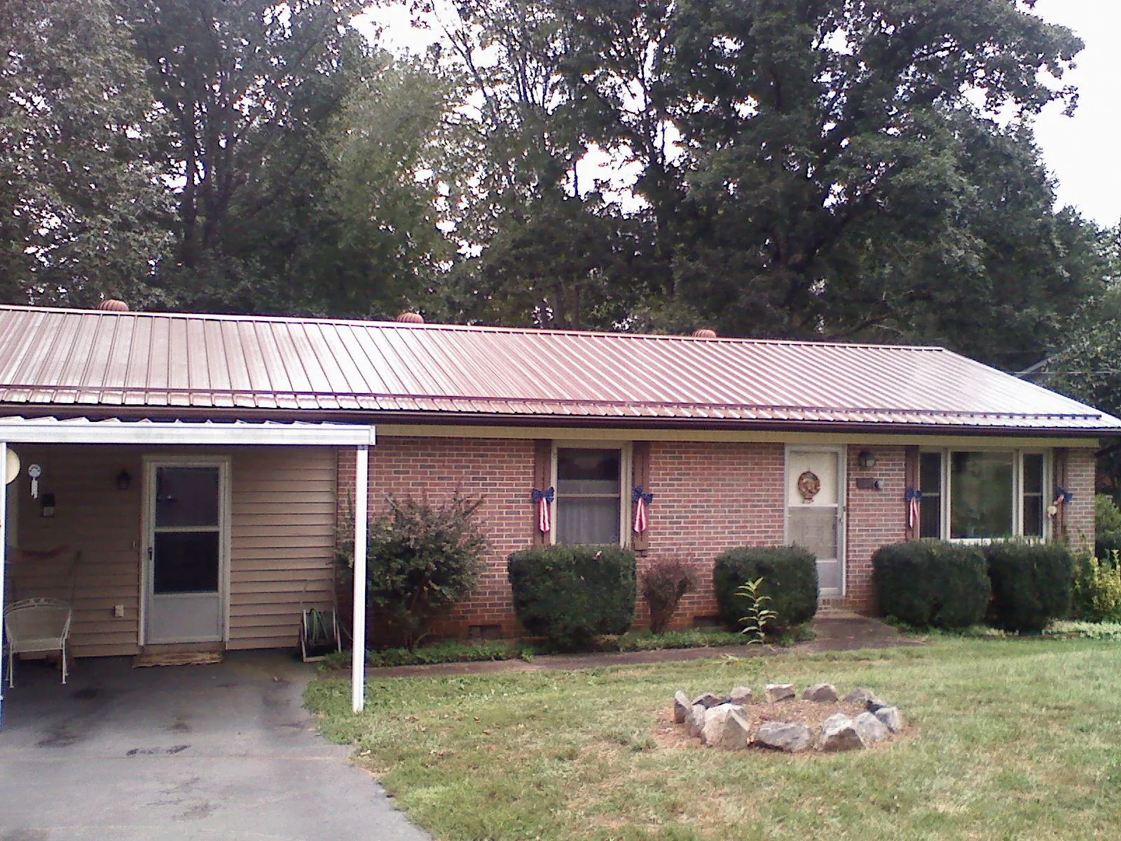 Bronze metal roof and carport on a brick ranch home — Roof Repair work by our crew in Havertown